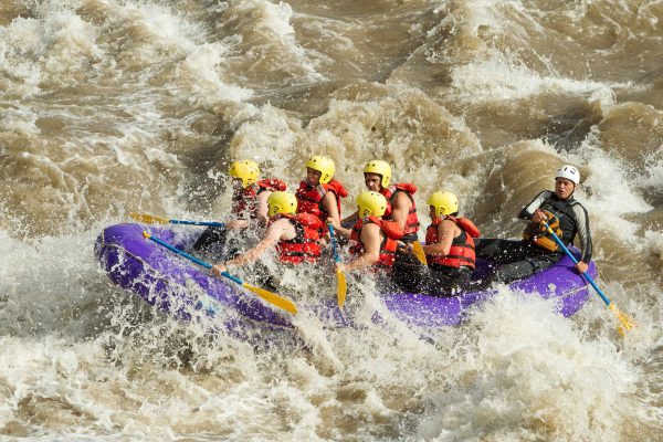 20997011 - a group of men and women, with a guide, white water rafting on the patate river, ecuador
